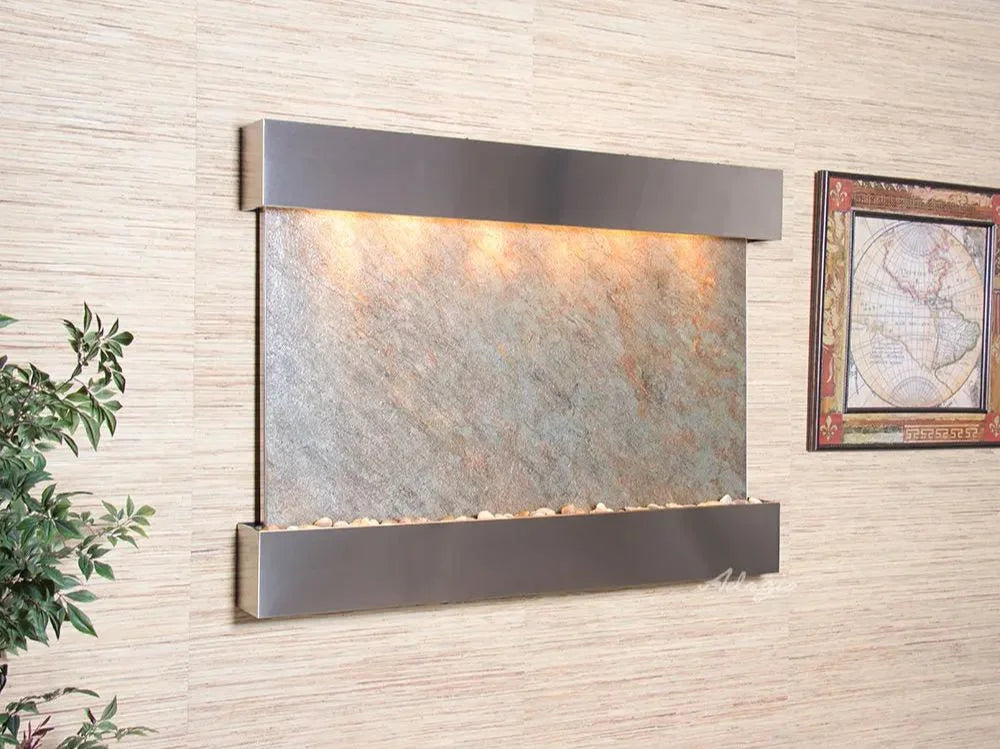 Wall-mounted water feature with light fixture on a textured wall.