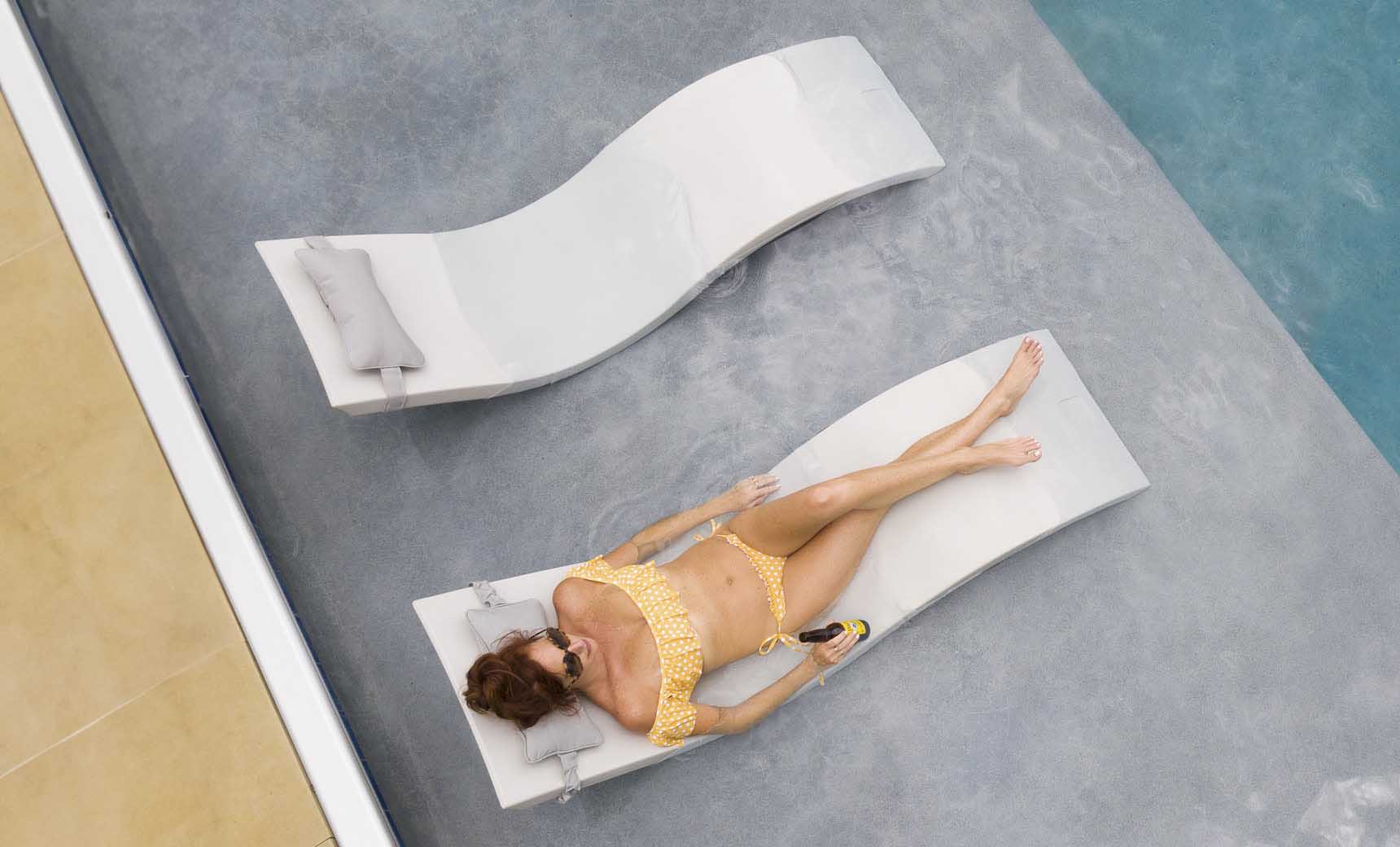 Signature pool chaise lounge with matching headrest pillow in vibrant blue fabric