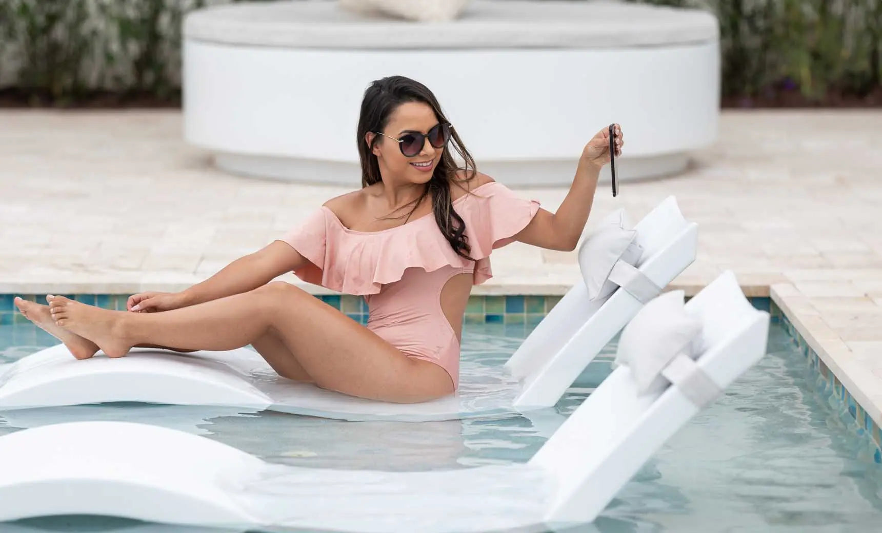 Signature pool chaise lounge with matching headrest pillow in vibrant blue fabric