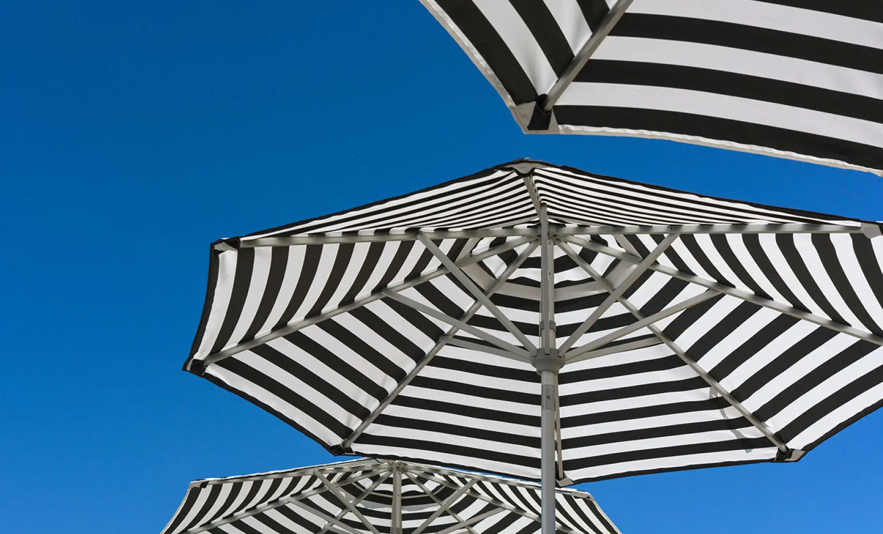 8.5-foot square Signature Series umbrella with a 360° tilt feature and black canopy