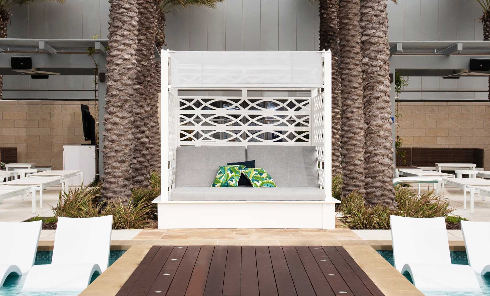 Shift Daybed featuring a sleek wooden frame with adjustable legs and a plush gray cushion.