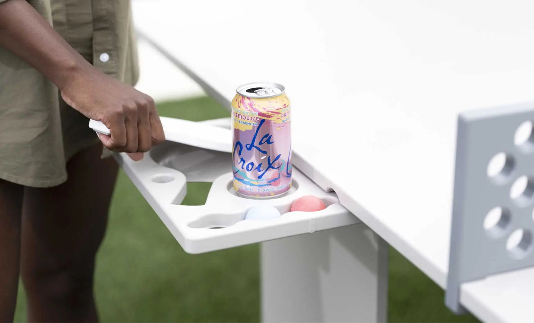 Table tennis set including racket, balls, and net stand in a travel case.