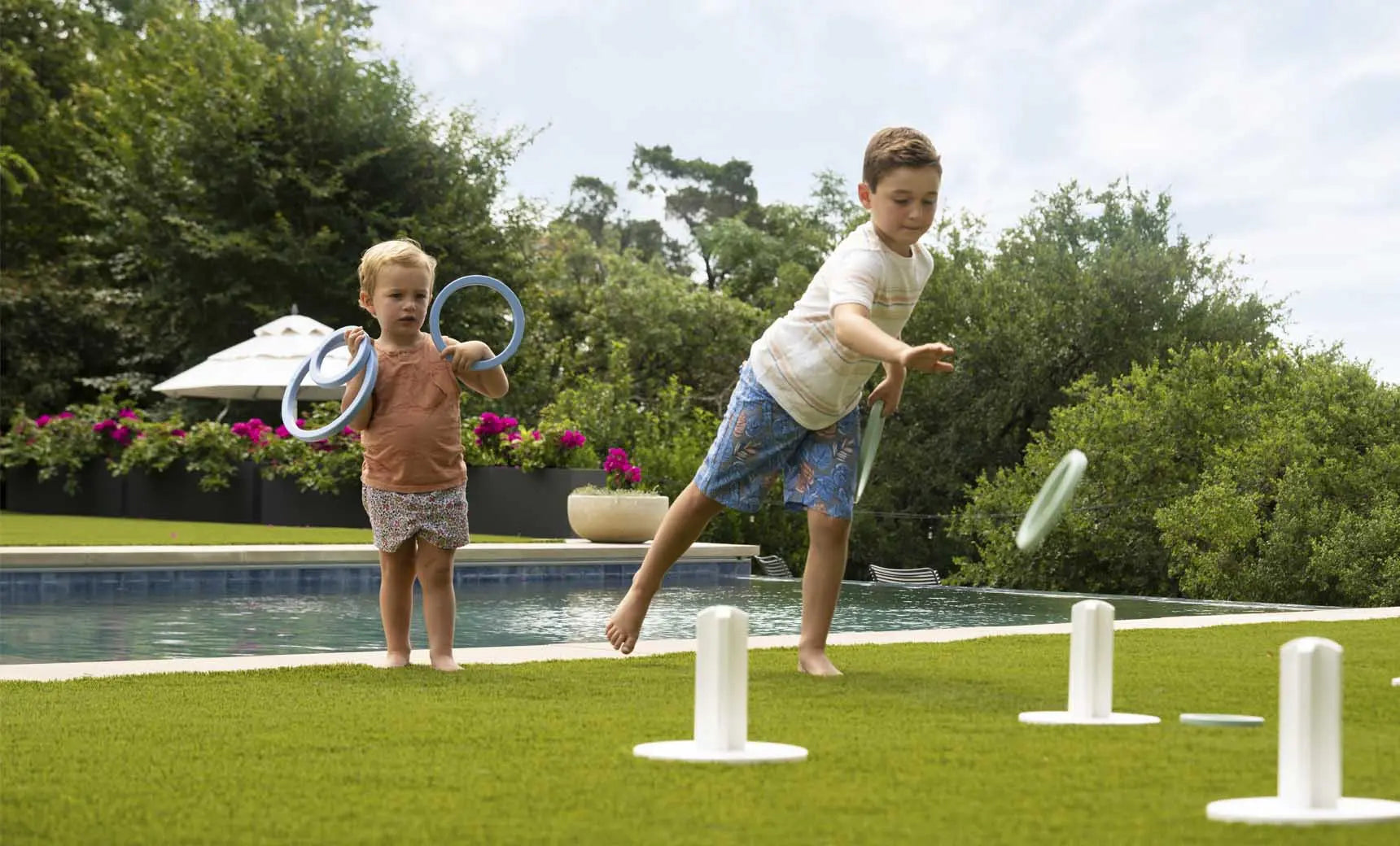Ring toss game set featuring three metal rings and a wooden stake.