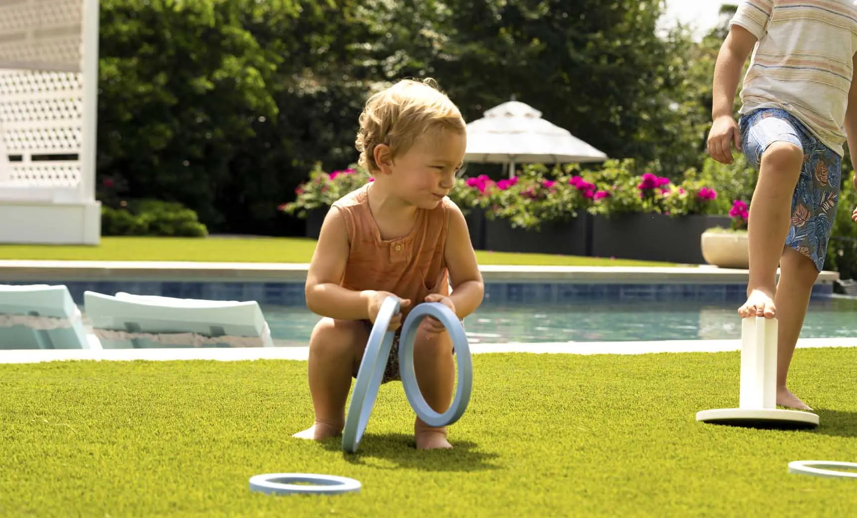 Ring toss game set featuring three metal rings and a wooden stake.