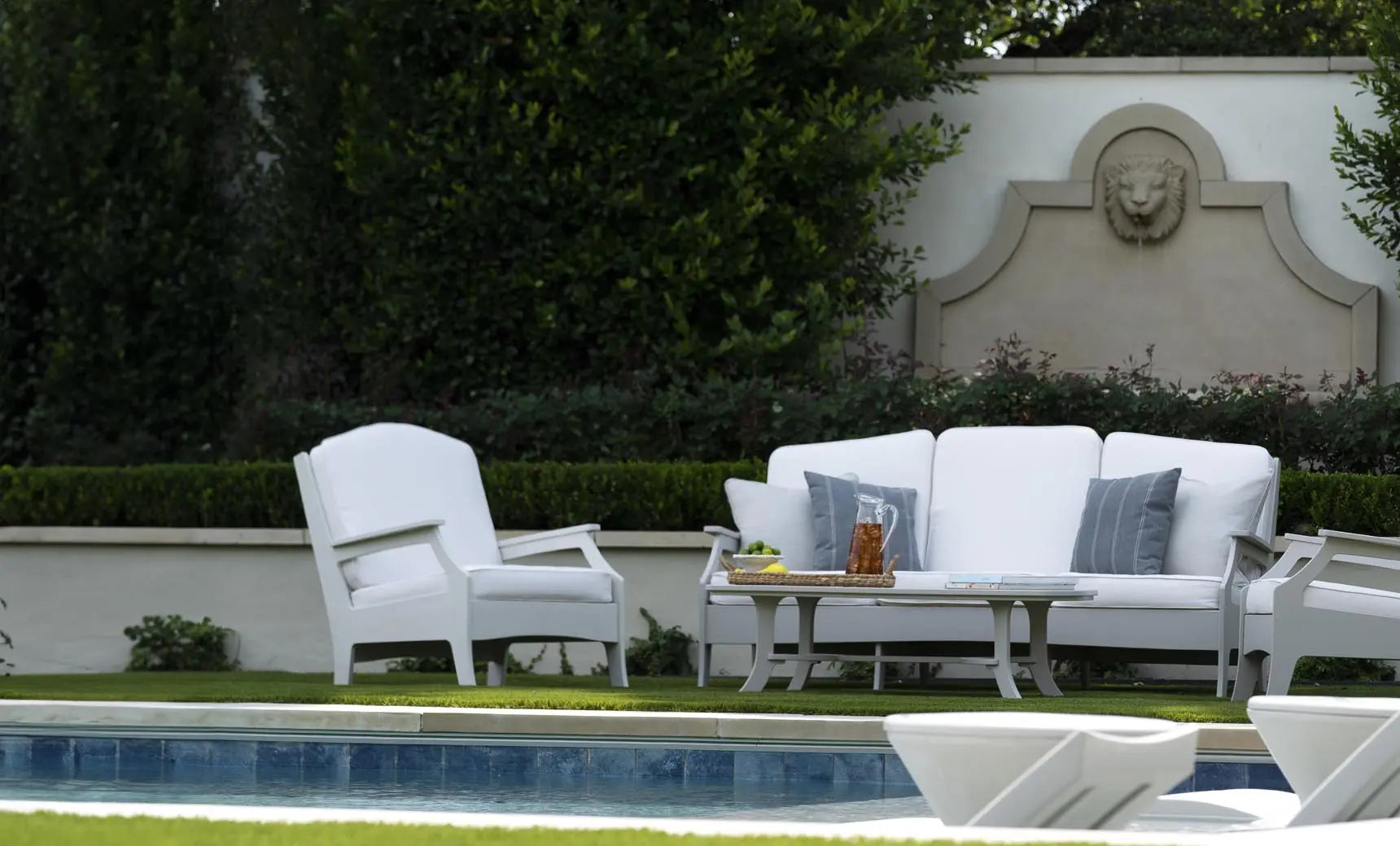 Legacy Sofa features a sleek modern design with clean lines and high-density foam cushioning in a dark charcoal fabric.