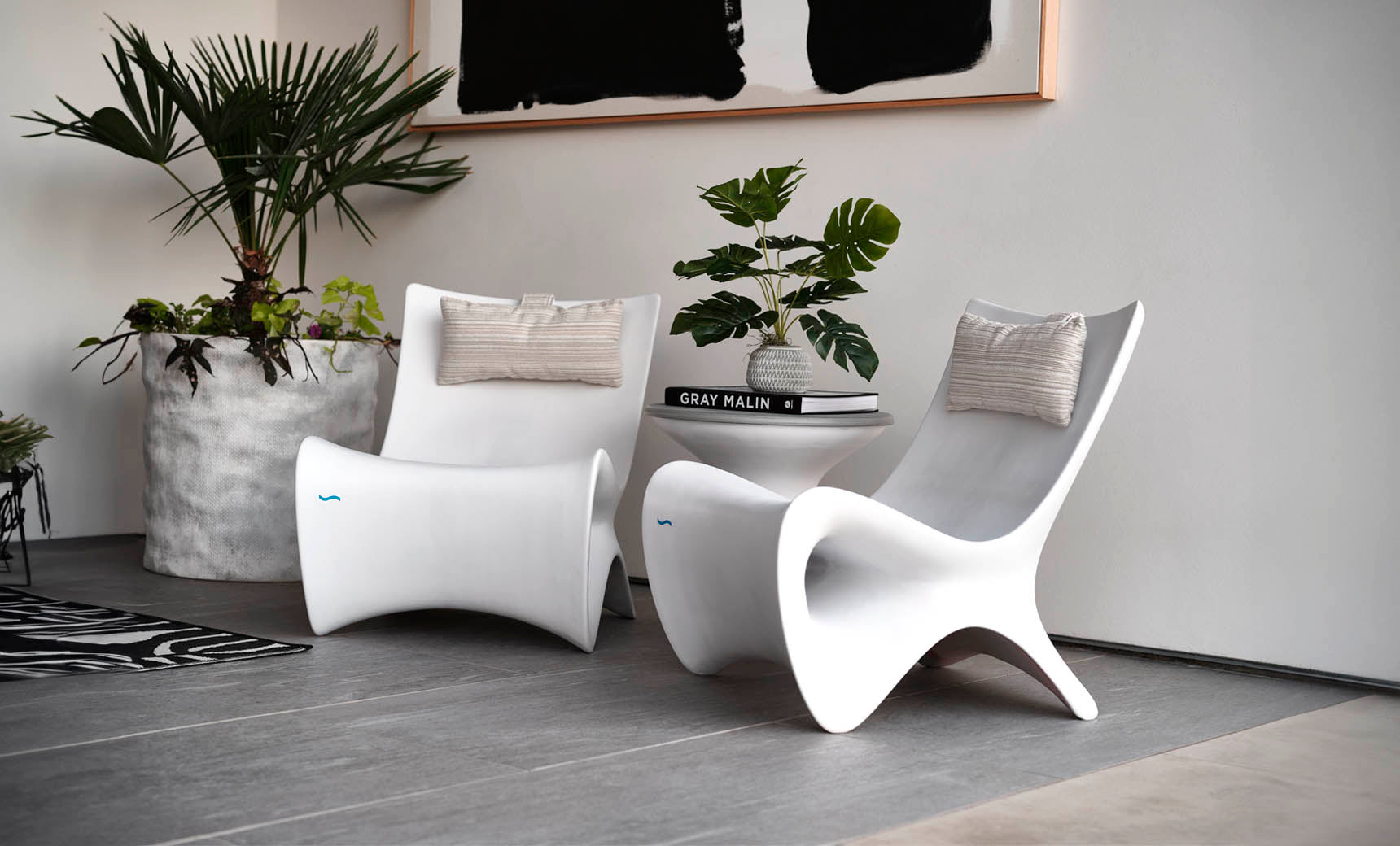 Autograph chair with brown leather seat and wooden frame paired with a matching brown side table.