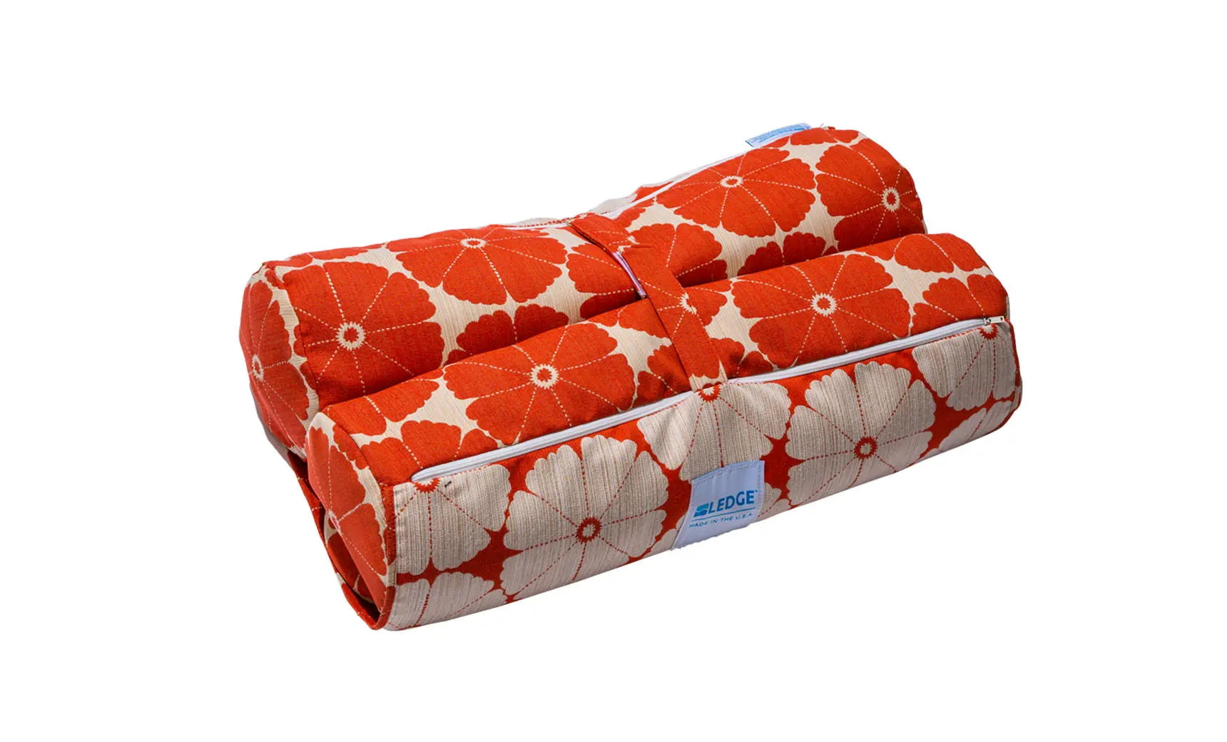 Laze Hammock in vibrant orange fabric suspended between two trees.