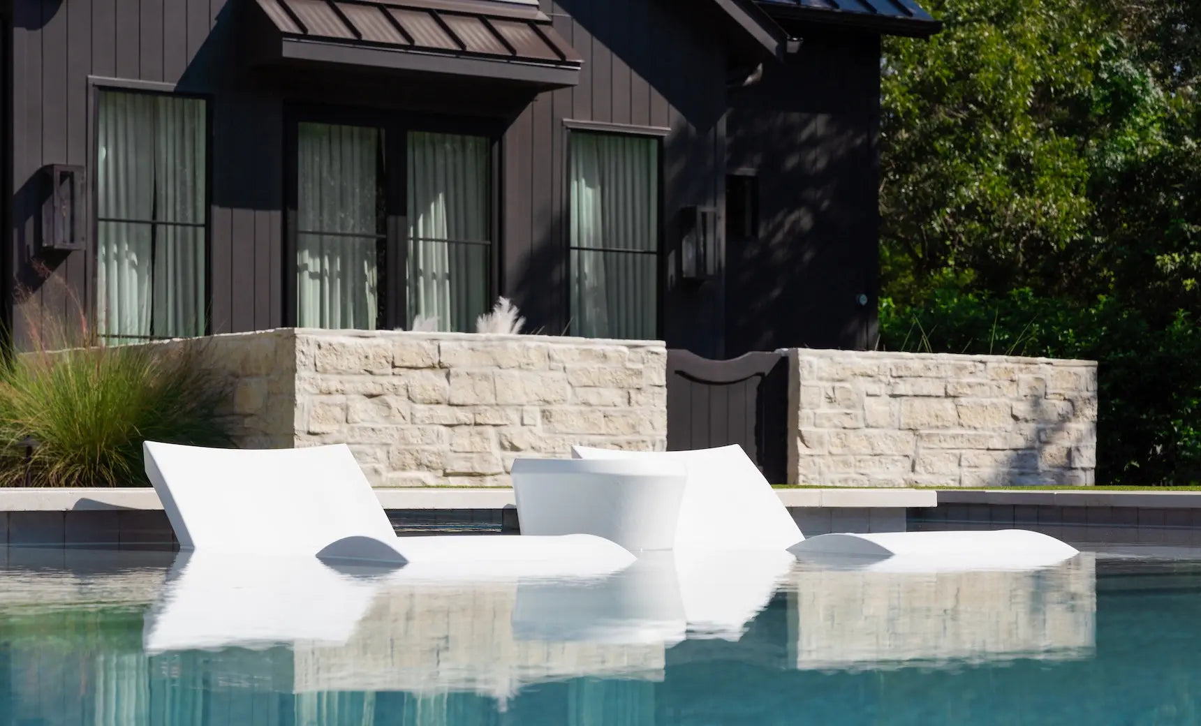 Signature chaise lounge chair paired with an Affinity side table in a pool setting.
