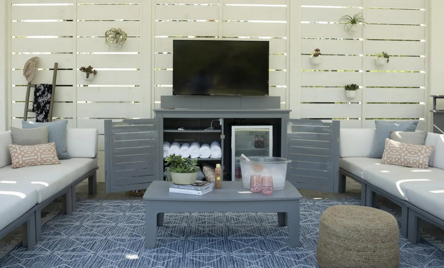 Mainstay bar credenza with wooden finish, glass doors, and pull-out shelf.