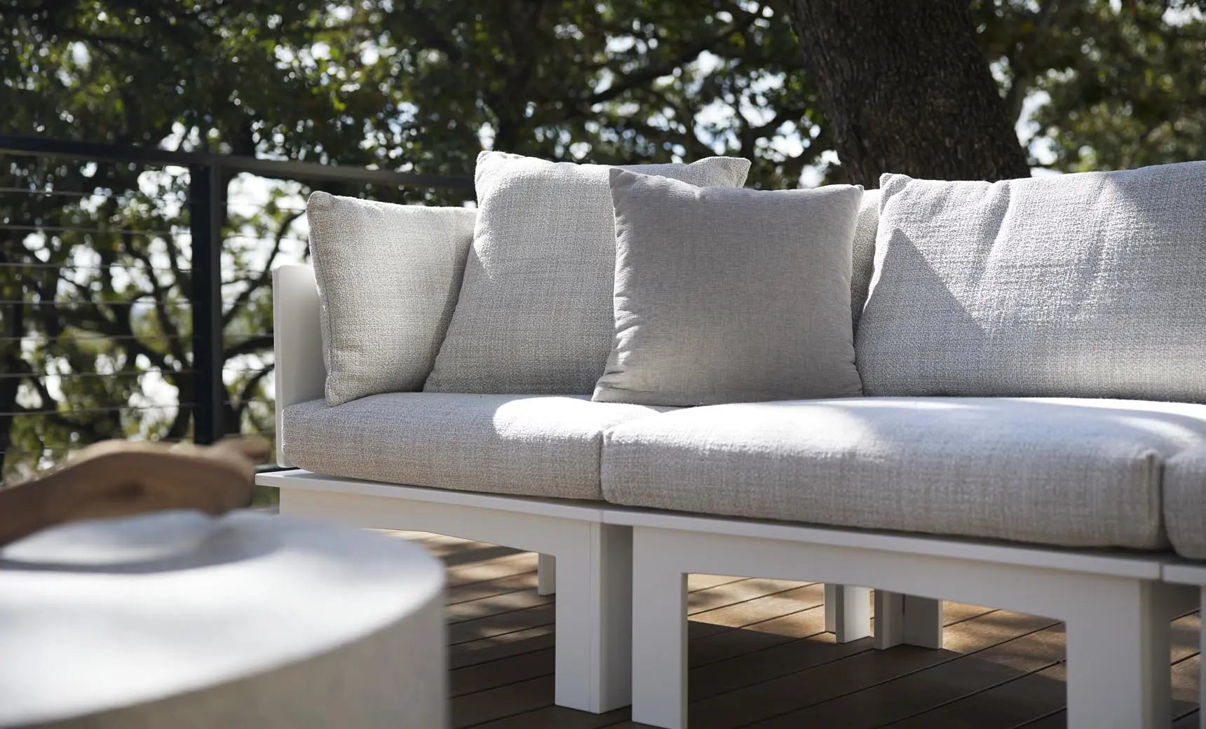 Mainstay sectional sofa in a left corner configuration with relaxed arm design and cream-colored fabric