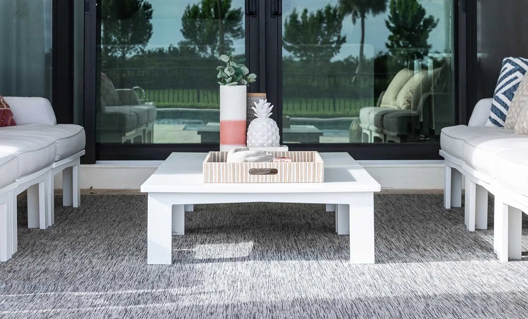 Mainstay square coffee table with a dark brown wooden top and metal legs.
