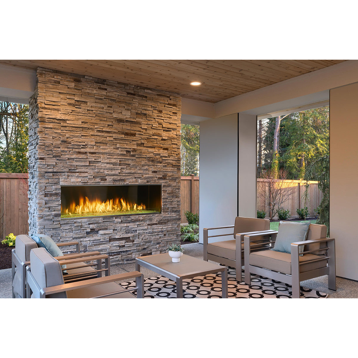 Majestic Lanai 60" outdoor linear gas fireplace with modern stainless steel front and glass panel.