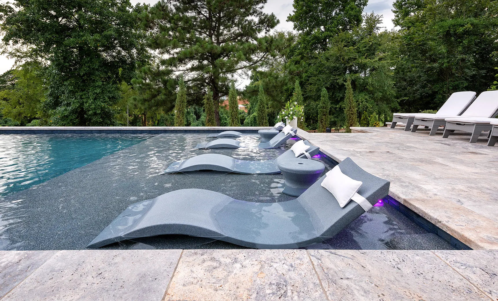 Signature pool chaise lounge set with coordinating side table in sleek black finish.