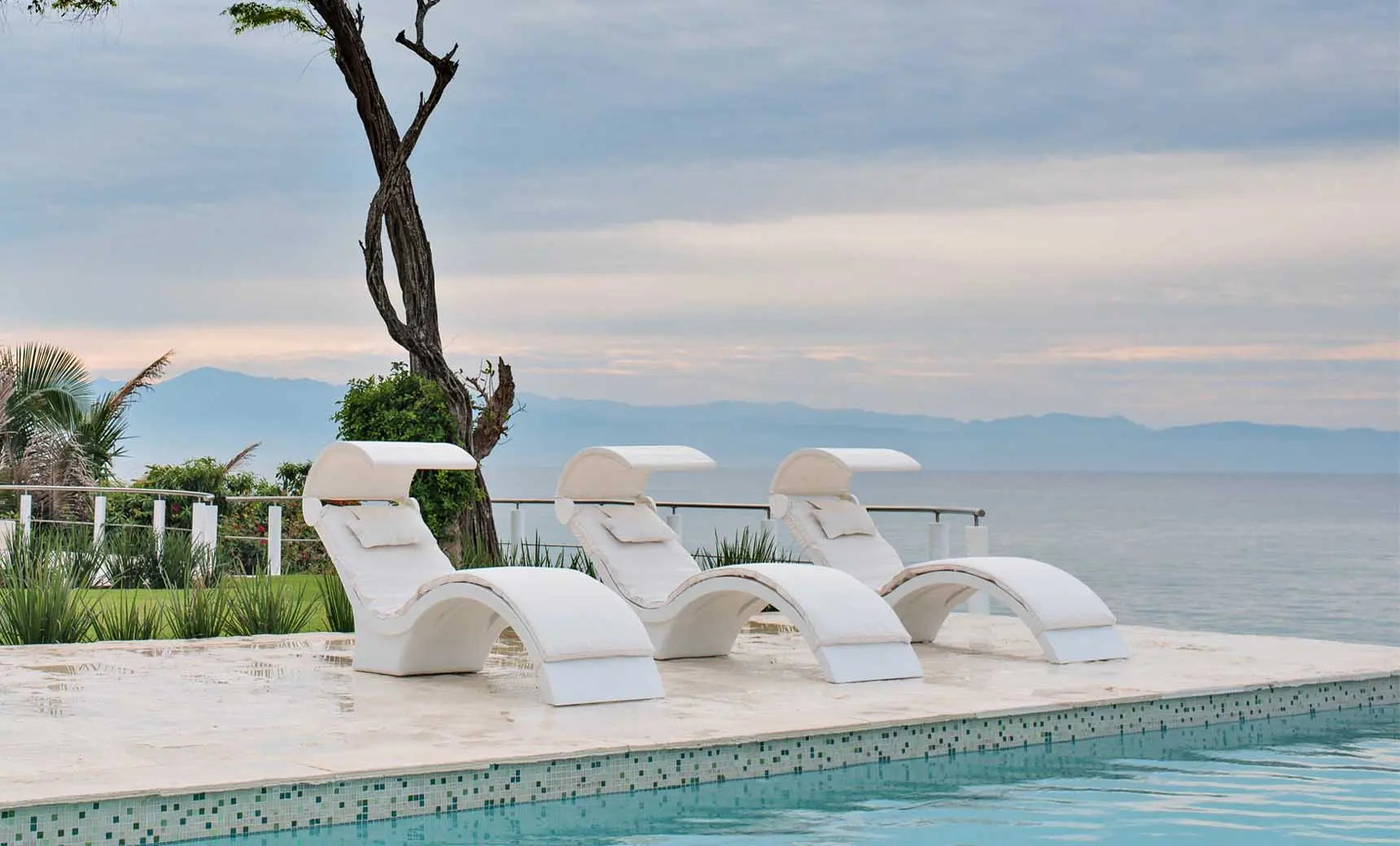 Signature chaise lounge with a brown fabric cushion and wooden frame.