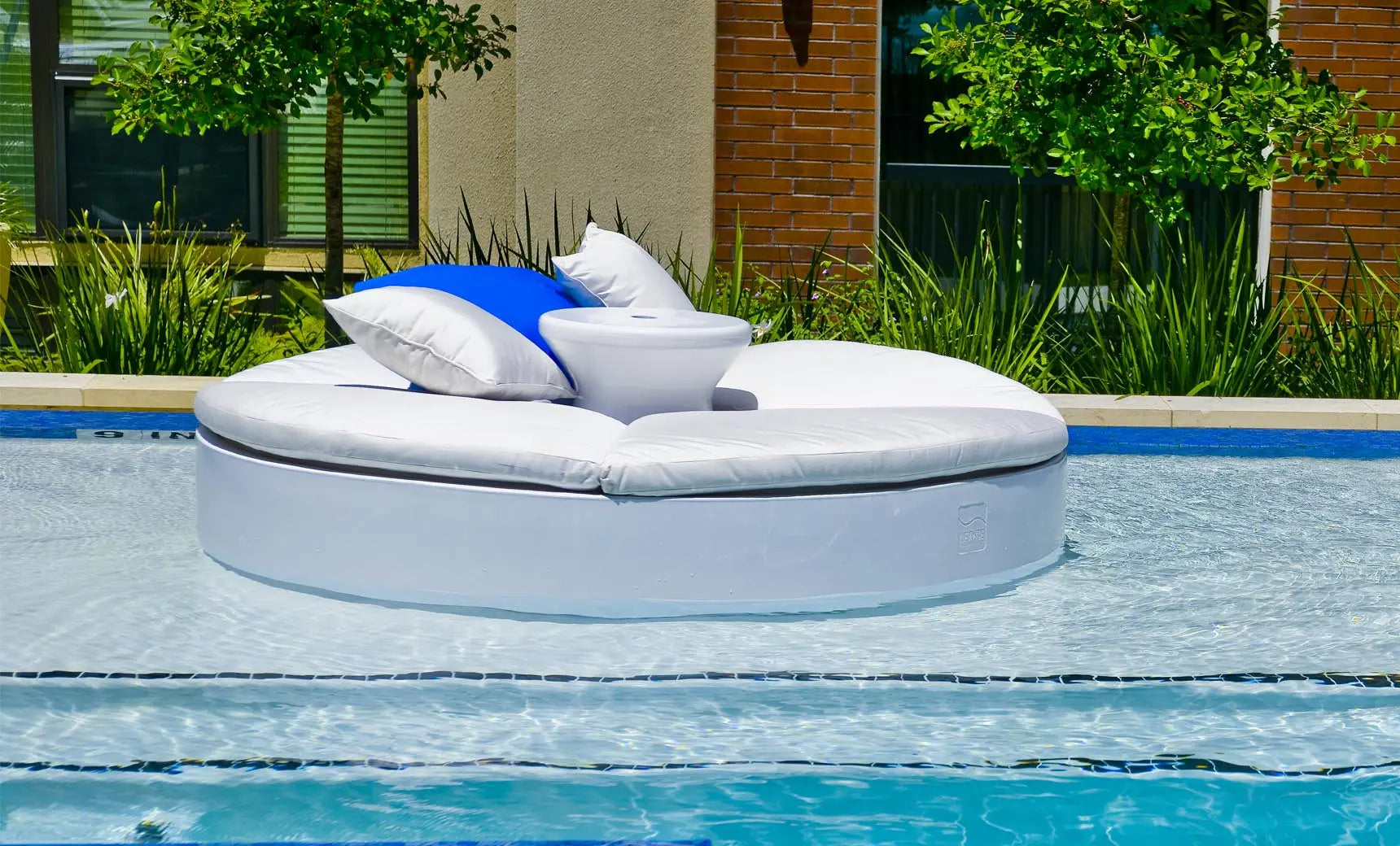 Signature Round Sunbed with a curved wooden frame and cushioned seat for relaxation.