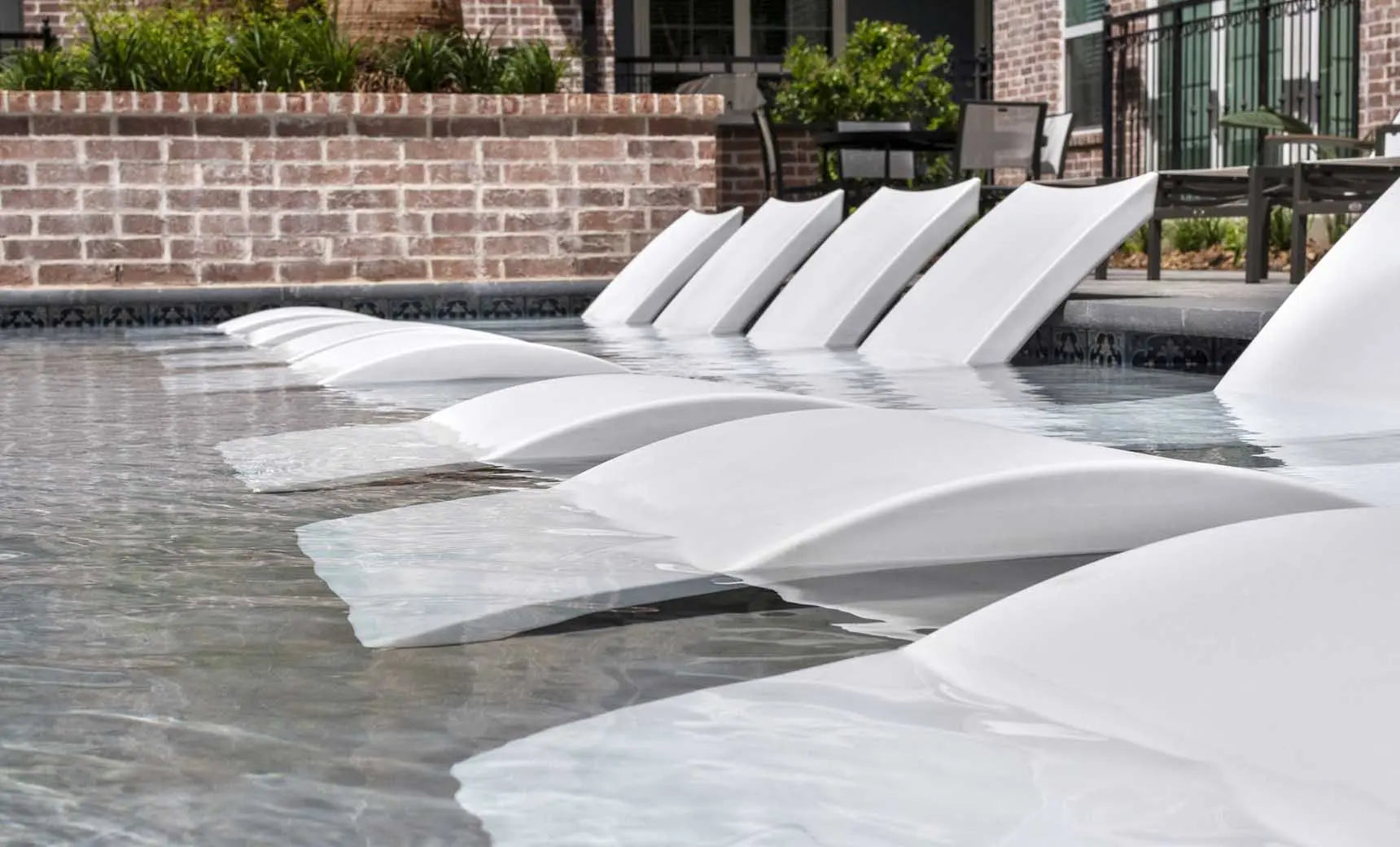 Signature pool chaise lounge set with coordinating side table in sleek black finish.