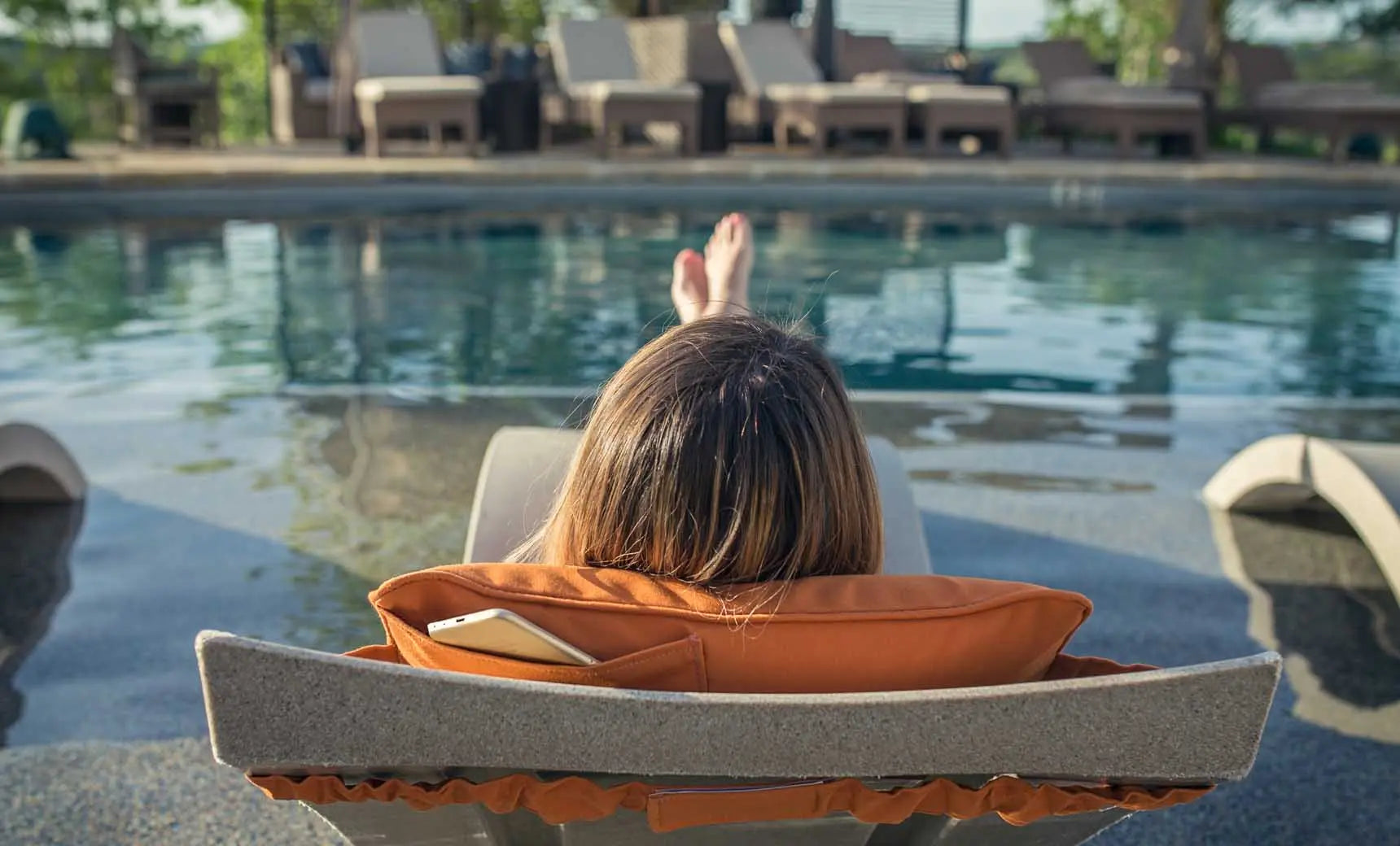 Signature headrest pillow with soft fabric cover and adjustable design for comfortable support during travel.