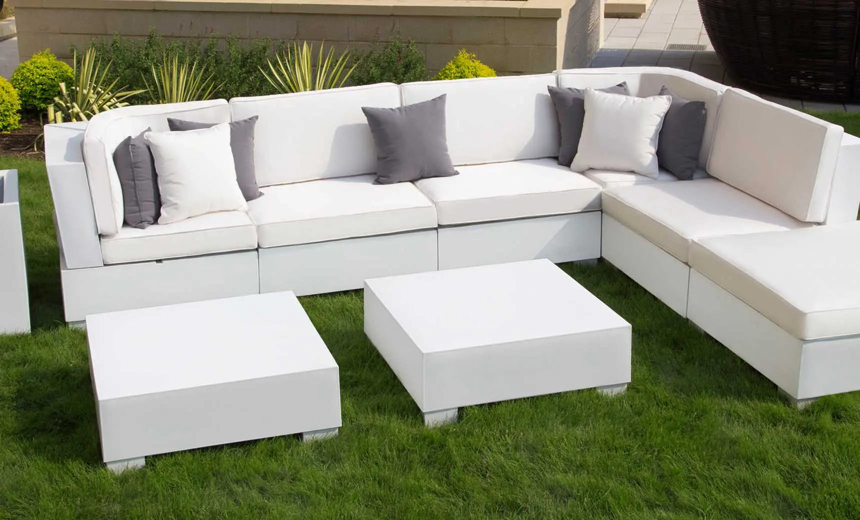 Signature Sectional Middle sofa in beige fabric with wooden legs and curved arms.