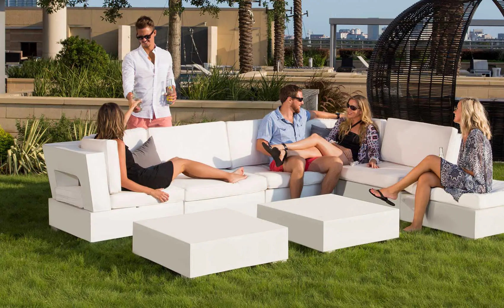 Signature Sectional Endcap in beige fabric with curved armrests and matching ottoman.