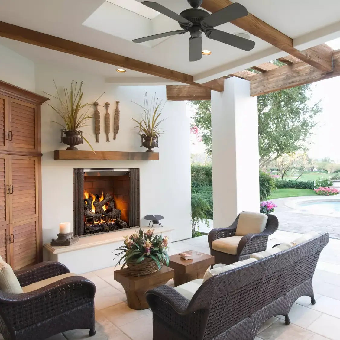 Majestic Castlewood 42-inch outdoor wood fireplace with stone surround and glass doors.