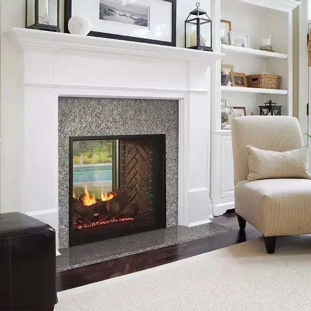 Majestic Fortress 36-inch indoor/outdoor see-through gas fireplace with glass front and stainless steel trim.