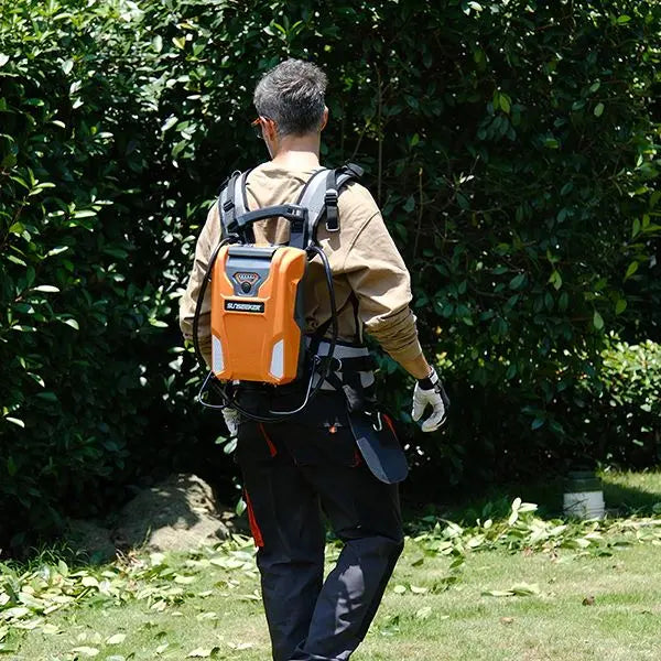 Person using a backpack-mounted gardening tool in a garden setting