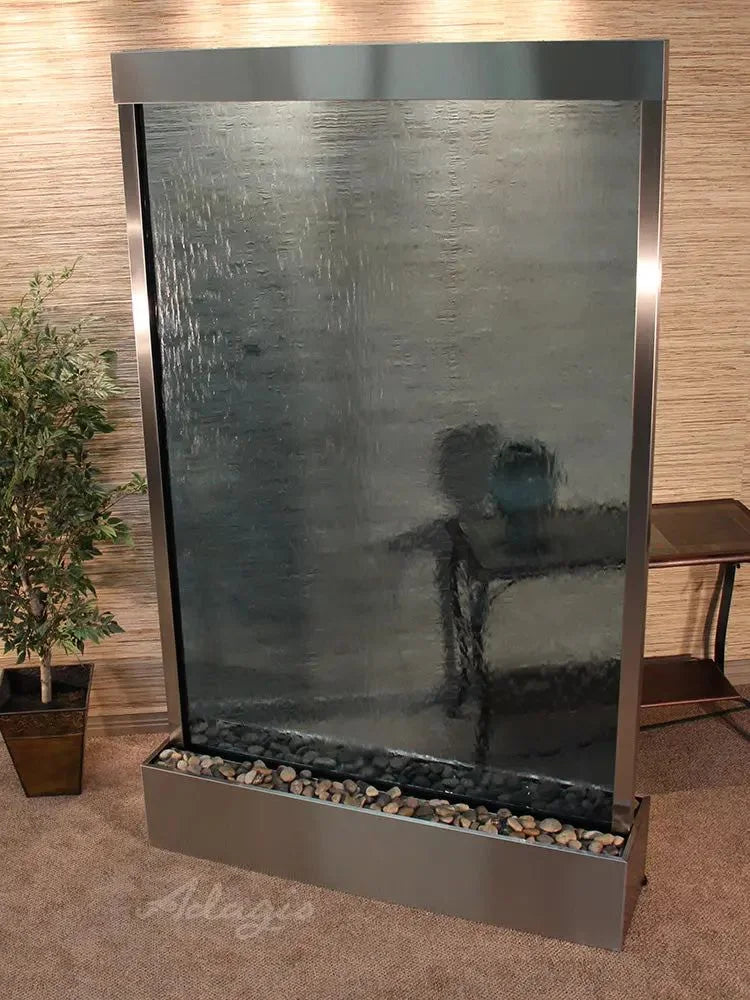 Modern indoor water feature with reflective surface and decorative elements.