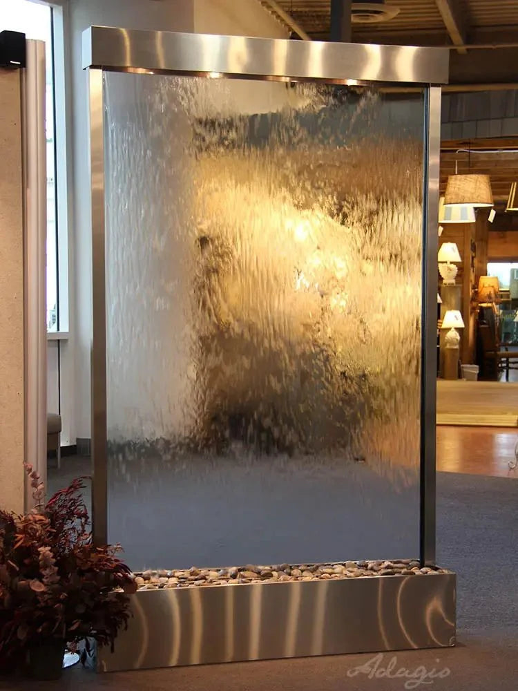 Wall-mounted water fountain with metallic finish in a room setting