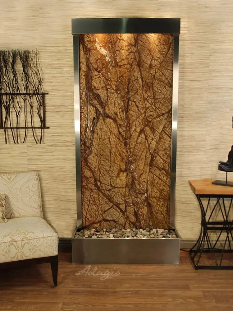 Decorative wall fountain with marble-like design in a room setting.