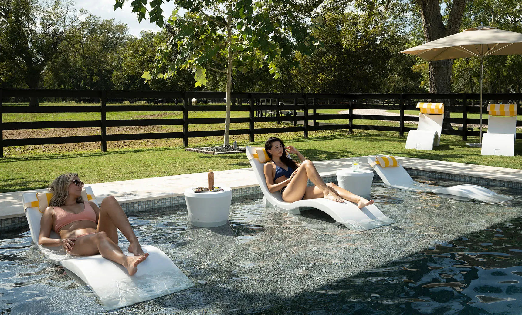 Signature chaise lounge chair paired with an Affinity side table in a pool setting.