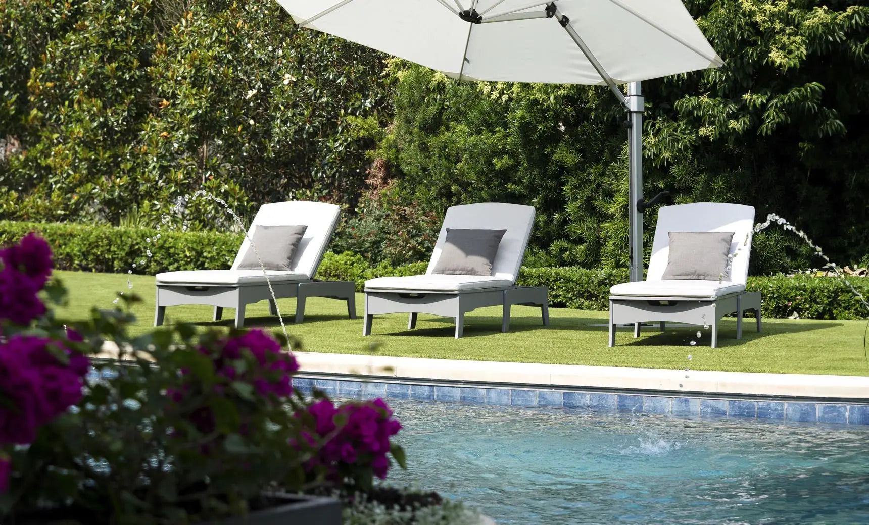 Legacy chaise lounge with brown leather upholstery, wooden frame, and armrests.