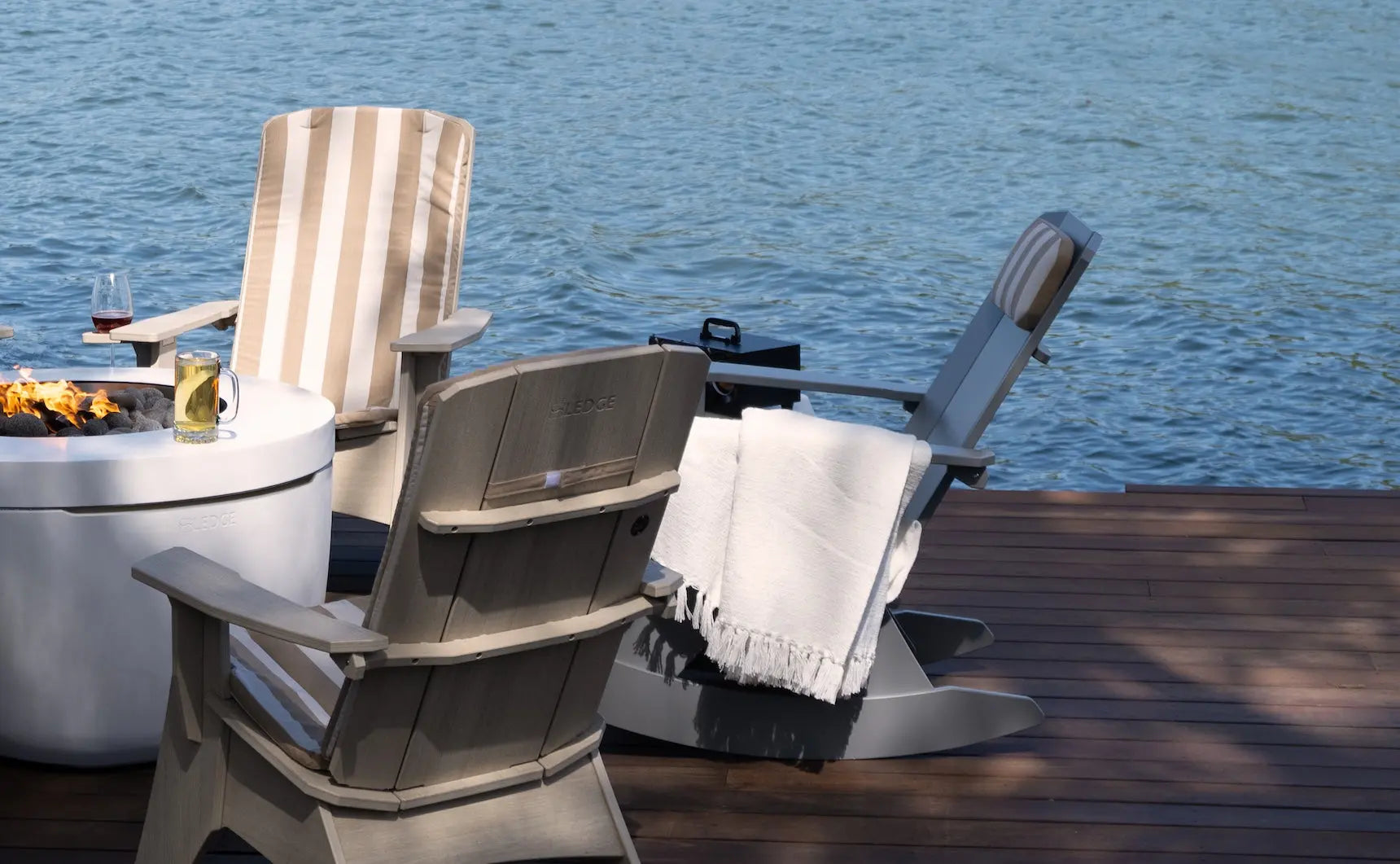 Mainstay Adirondack rocker in weathered pine finish with cushioned seat and armrests