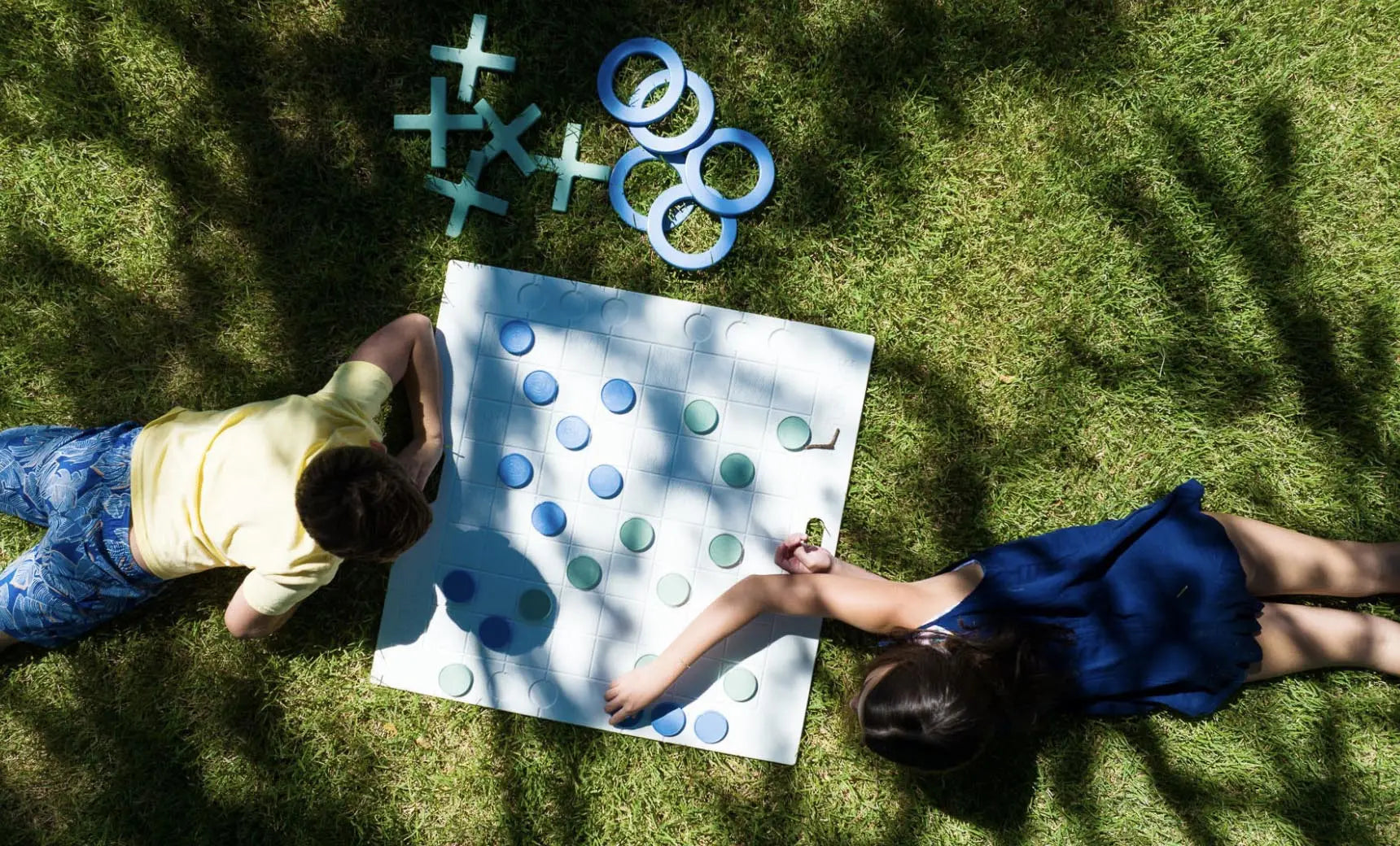 Checkers and Tic Tac Toe game board with black and red checkers pieces and yellow and blue tic tac toe tokens