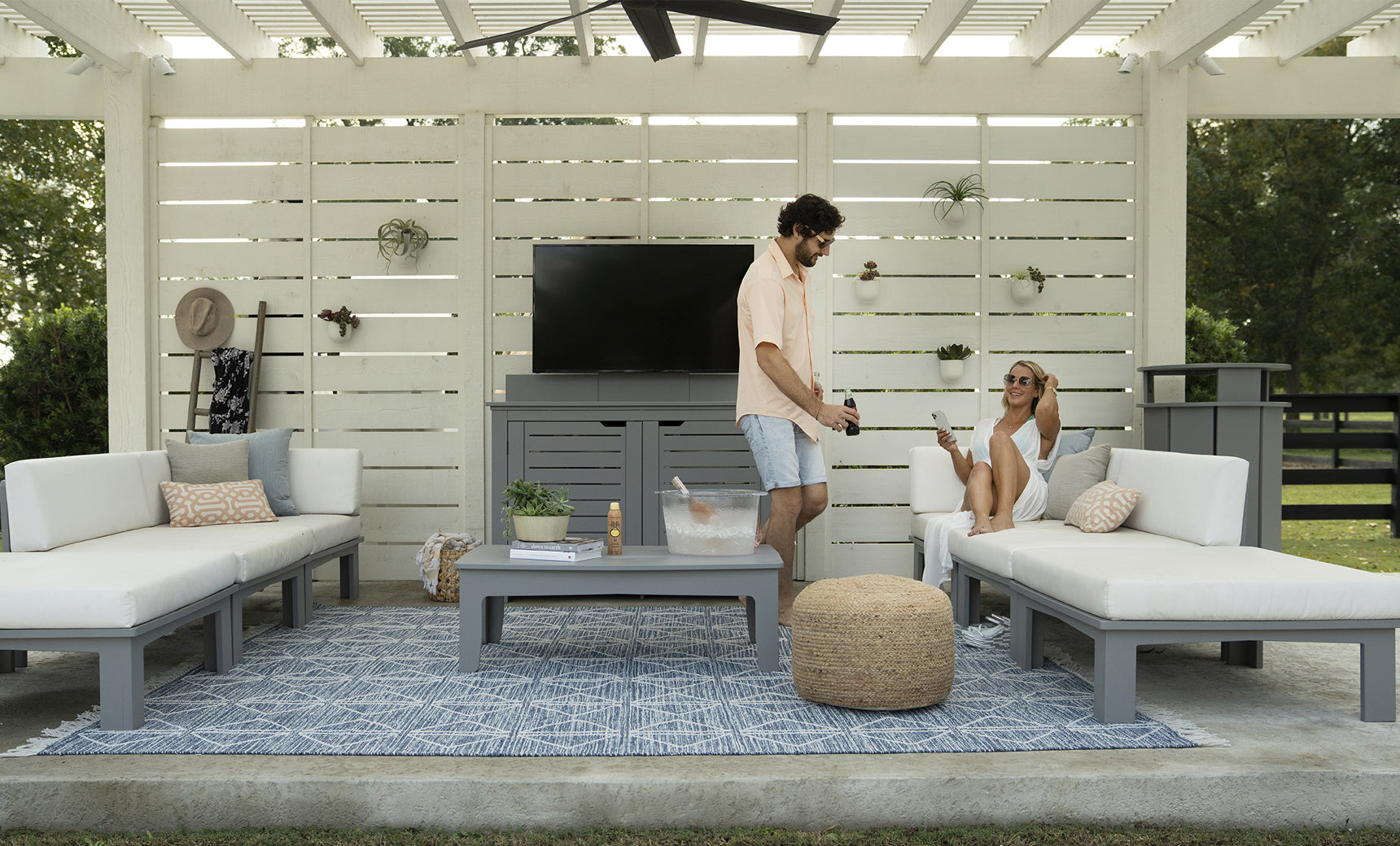 Mainstay outdoor trash bin in gray with a hinged lid and four wheels.