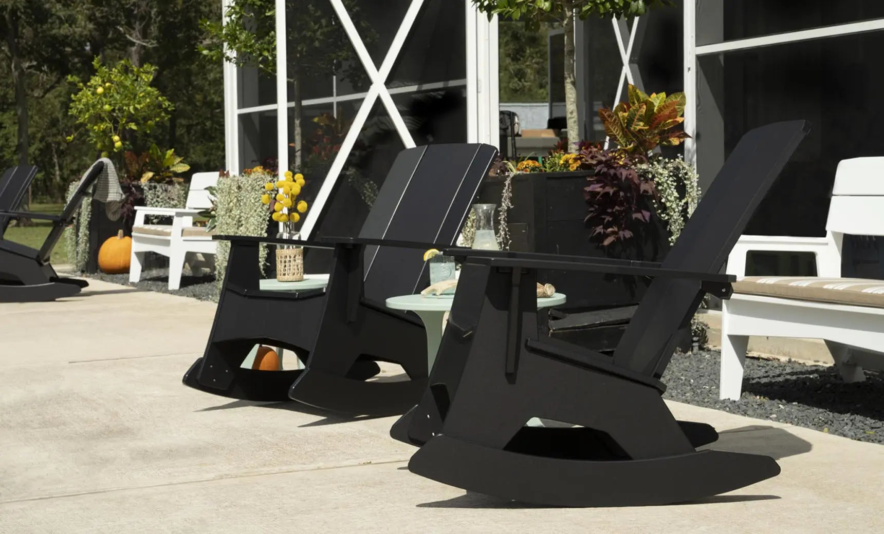 Mainstay Adirondack rocker in weathered pine finish with cushioned seat and armrests