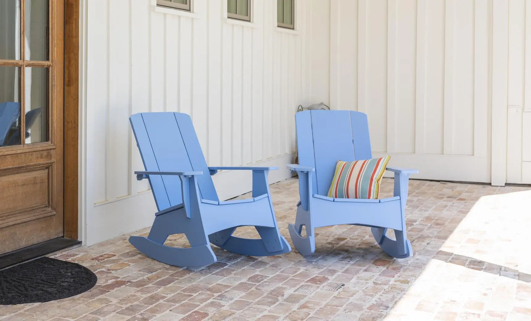 Mainstay Adirondack rocker in weathered pine finish with cushioned seat and armrests
