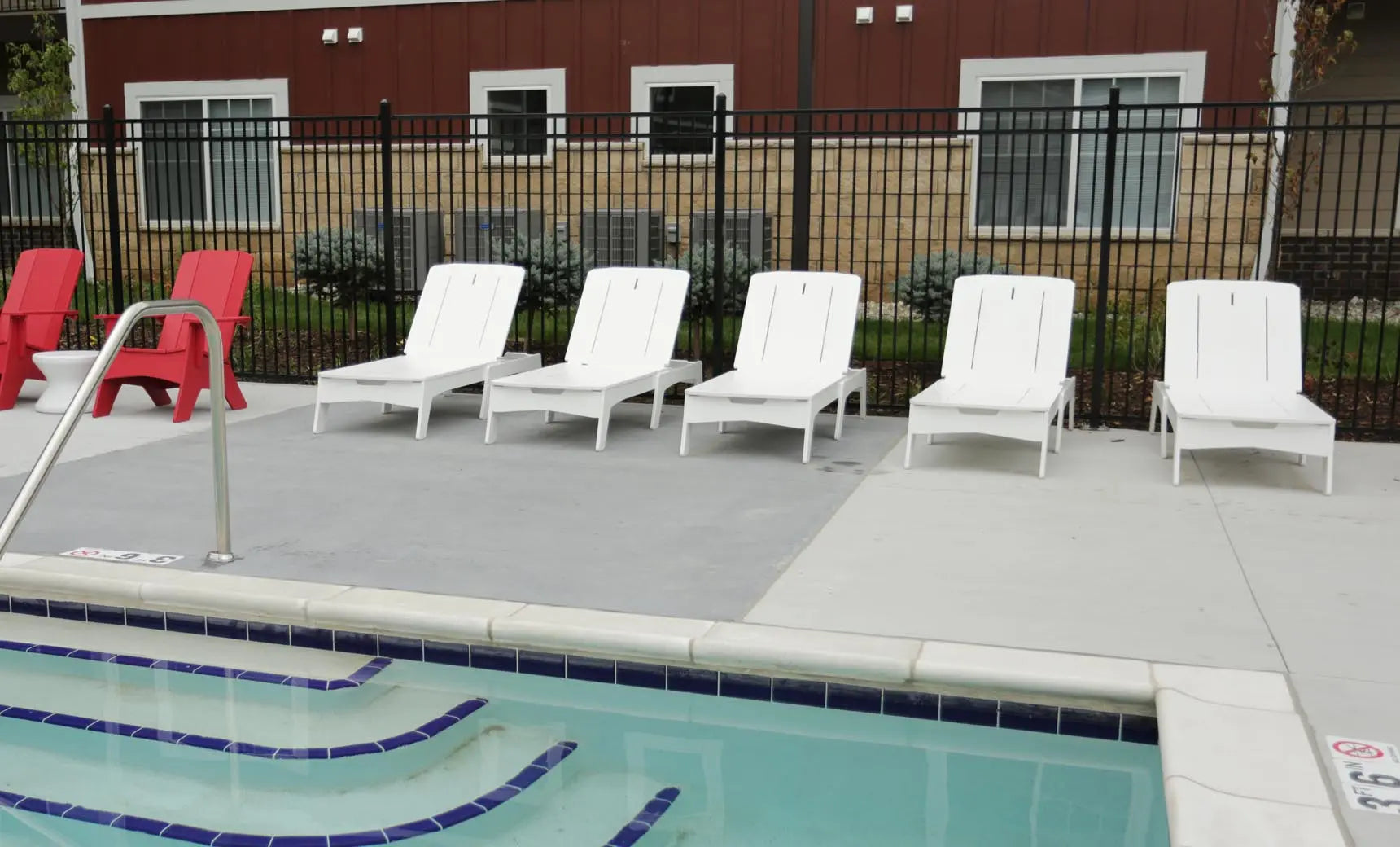 Mainstay chaise lounge in gray fabric with wooden frame and footrest in raised position.