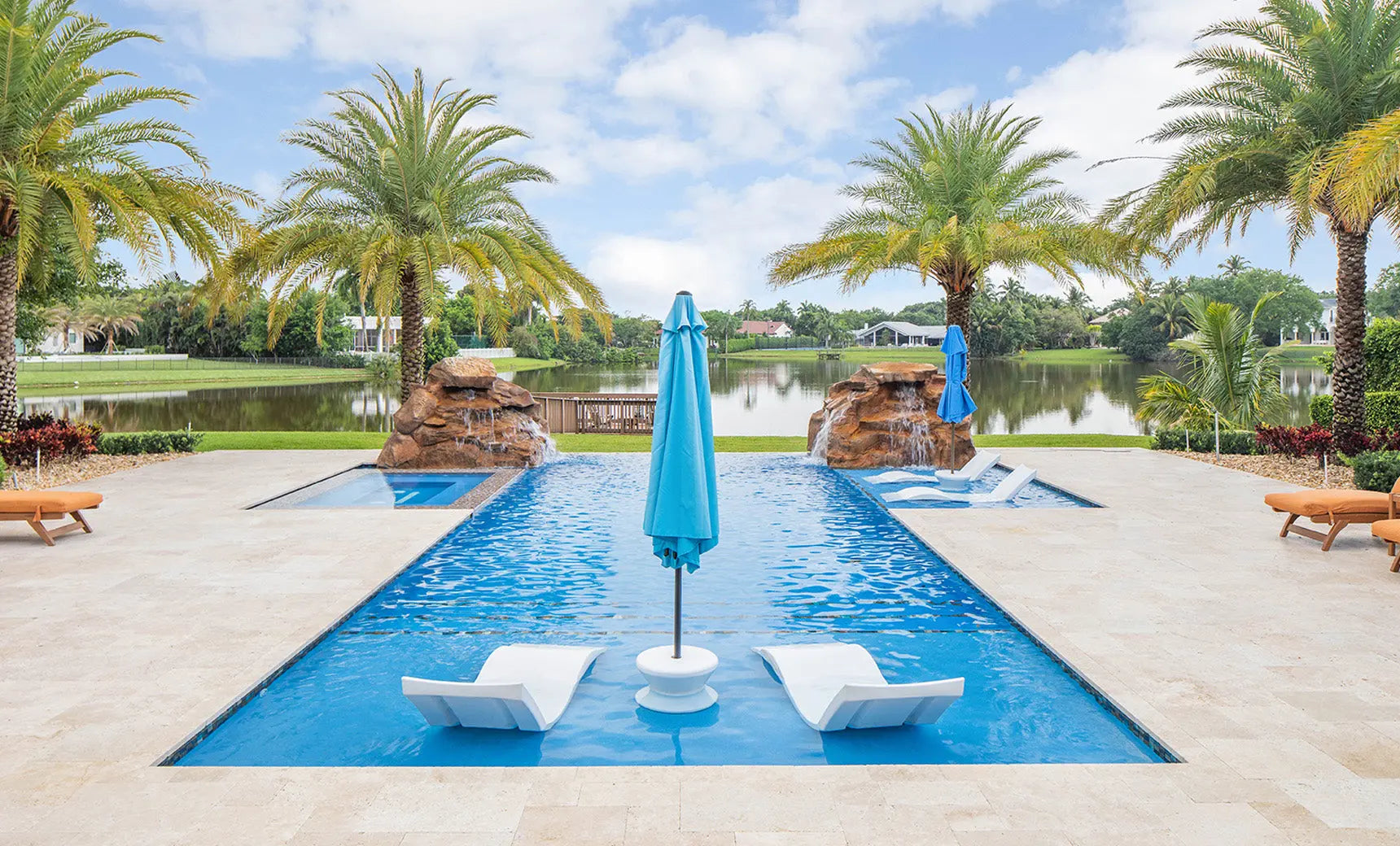 Signature chaise lounge in a modern design paired with a sleek side table for an in-pool setup.