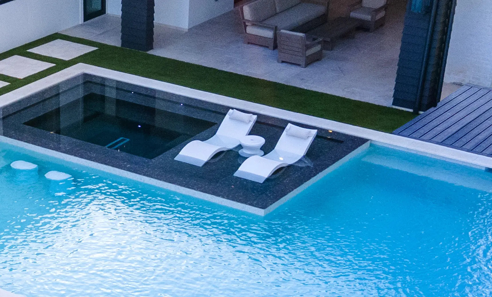 Signature chaise headrest pillow paired with a side table for in-pool use, both made of durable materials.