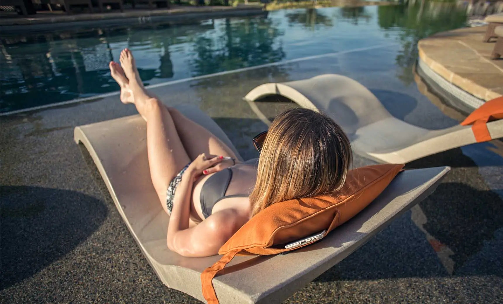 Signature headrest pillow with soft fabric cover and adjustable design for comfortable support during travel.