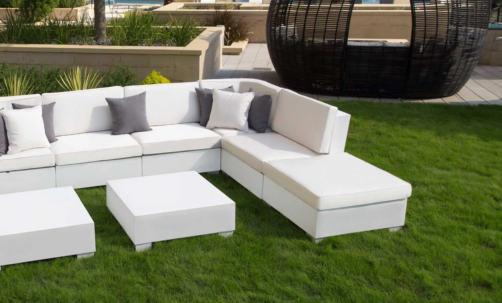 Signature Sectional Ottoman in beige fabric with wooden legs and an ottoman seat.