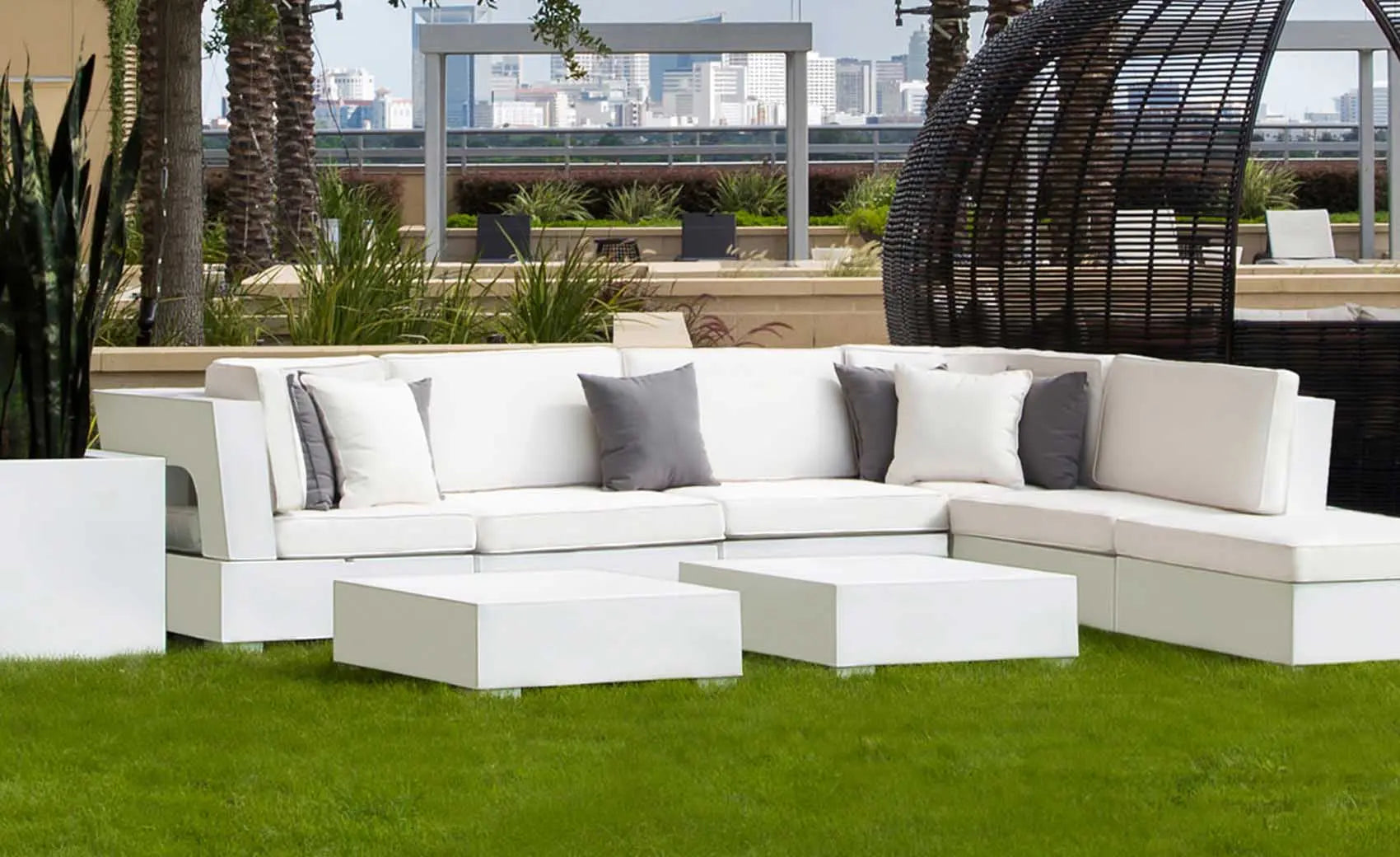 Signature Sectional Endcap in beige fabric with curved armrests and matching ottoman.