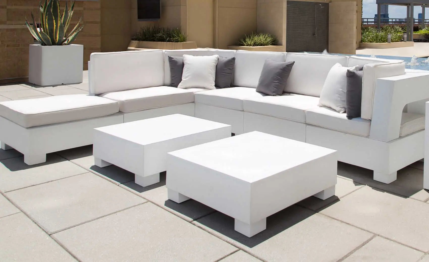 Signature Sectional Endcap in beige fabric with curved armrests and matching ottoman.