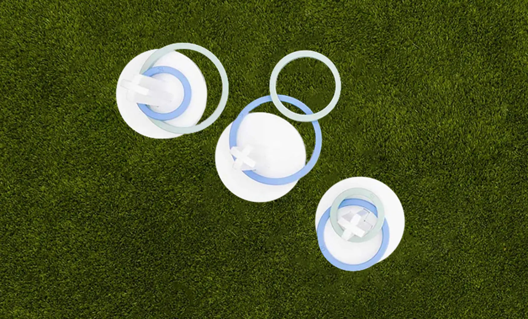 Ring toss game set featuring three metal rings and a wooden stake.