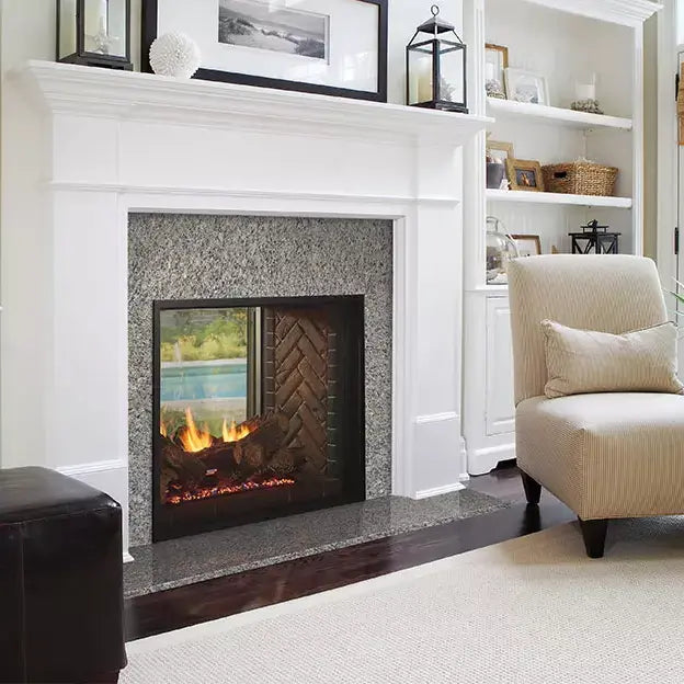 Majestic Fortress 36-inch indoor/outdoor see-through gas fireplace with glass front and stainless steel trim.