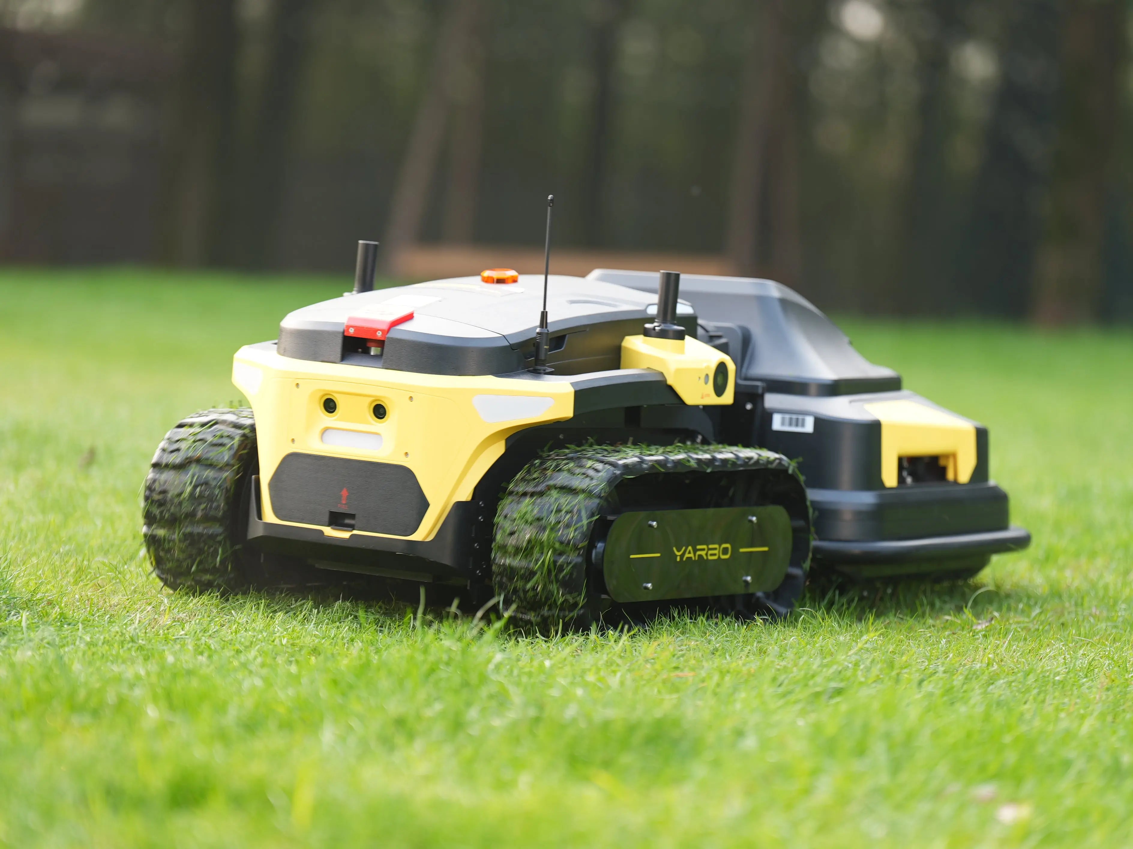 Robotic lawn mower on grass with a blurred natural background