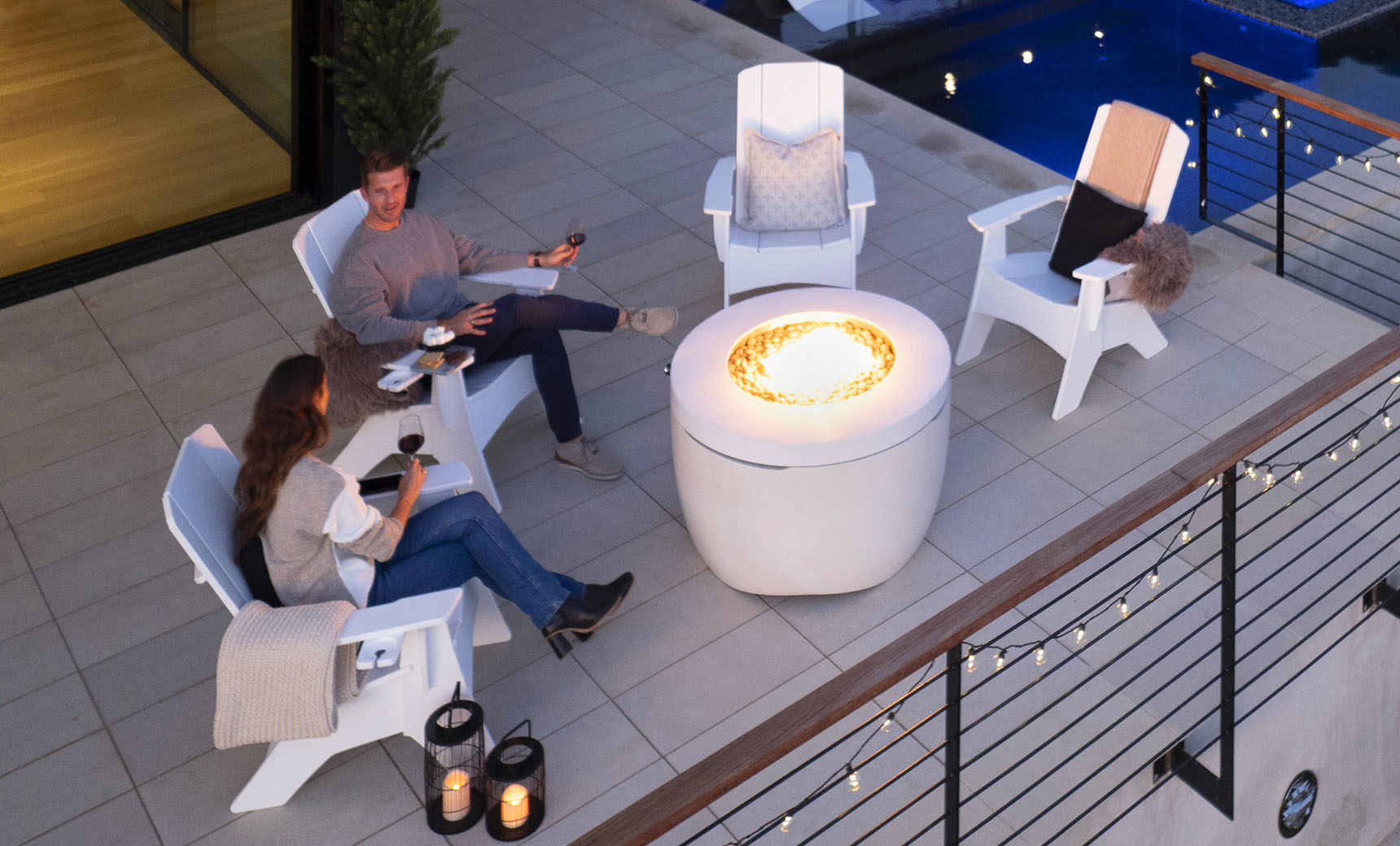 Halo Firepit with four Adirondack chairs surrounding it in a rustic style.