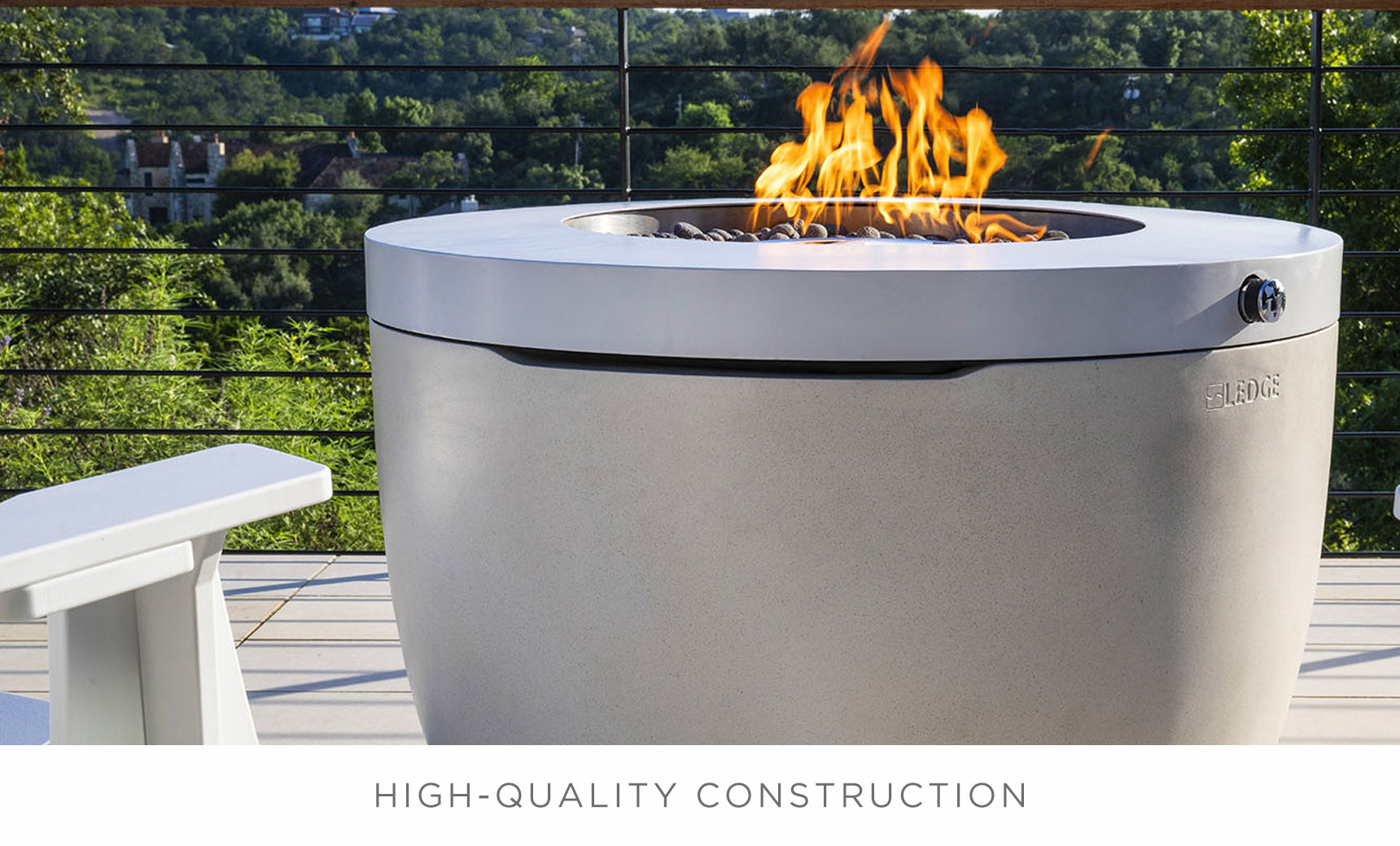 Halo firepit with gray finish, glass sides, and a built-in seating area.