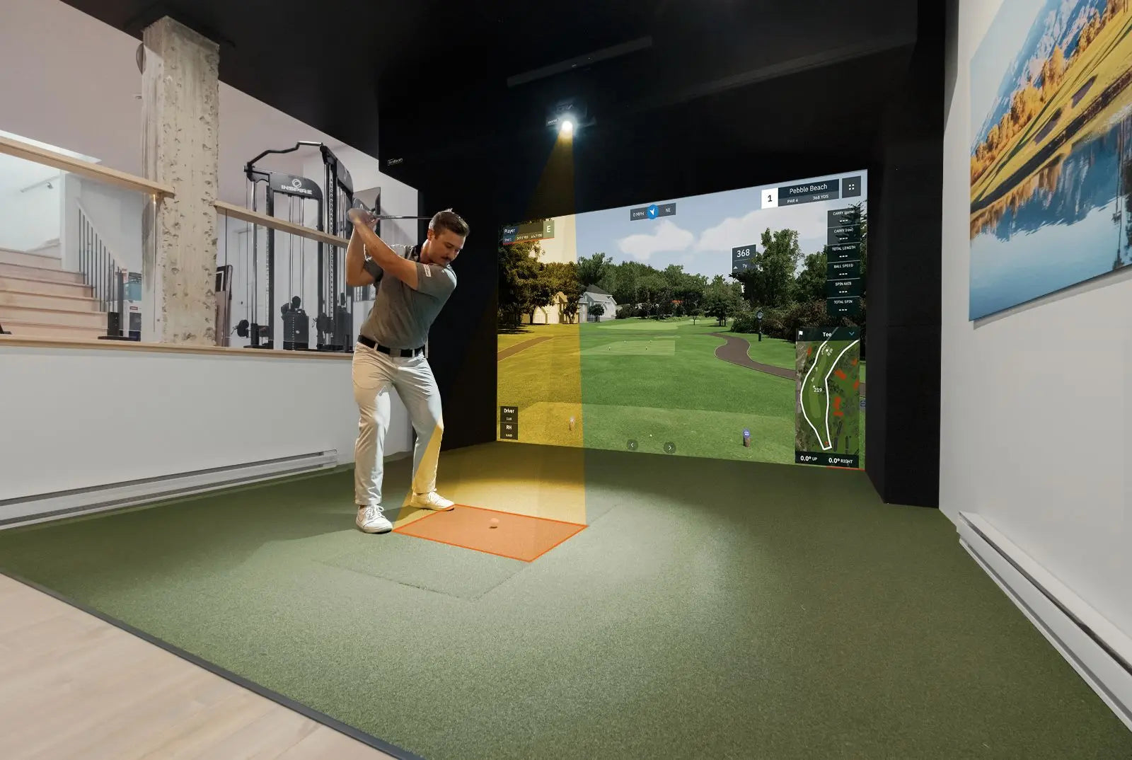 Person playing golf in a virtual reality simulator room.
